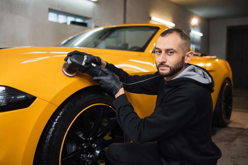 AutoShine technician polishing a yellow sports car during a high-end mobile detailing service in Chicago