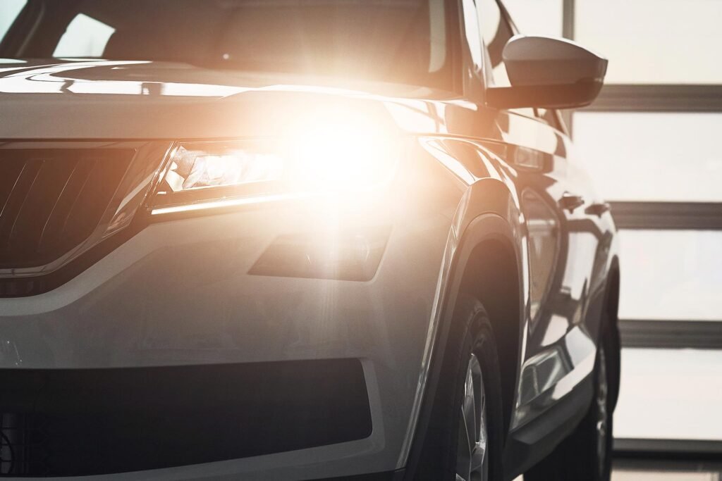 Shiny headlights and polished hood of a luxury vehicle after professional detailing by AutoShine in Chicago